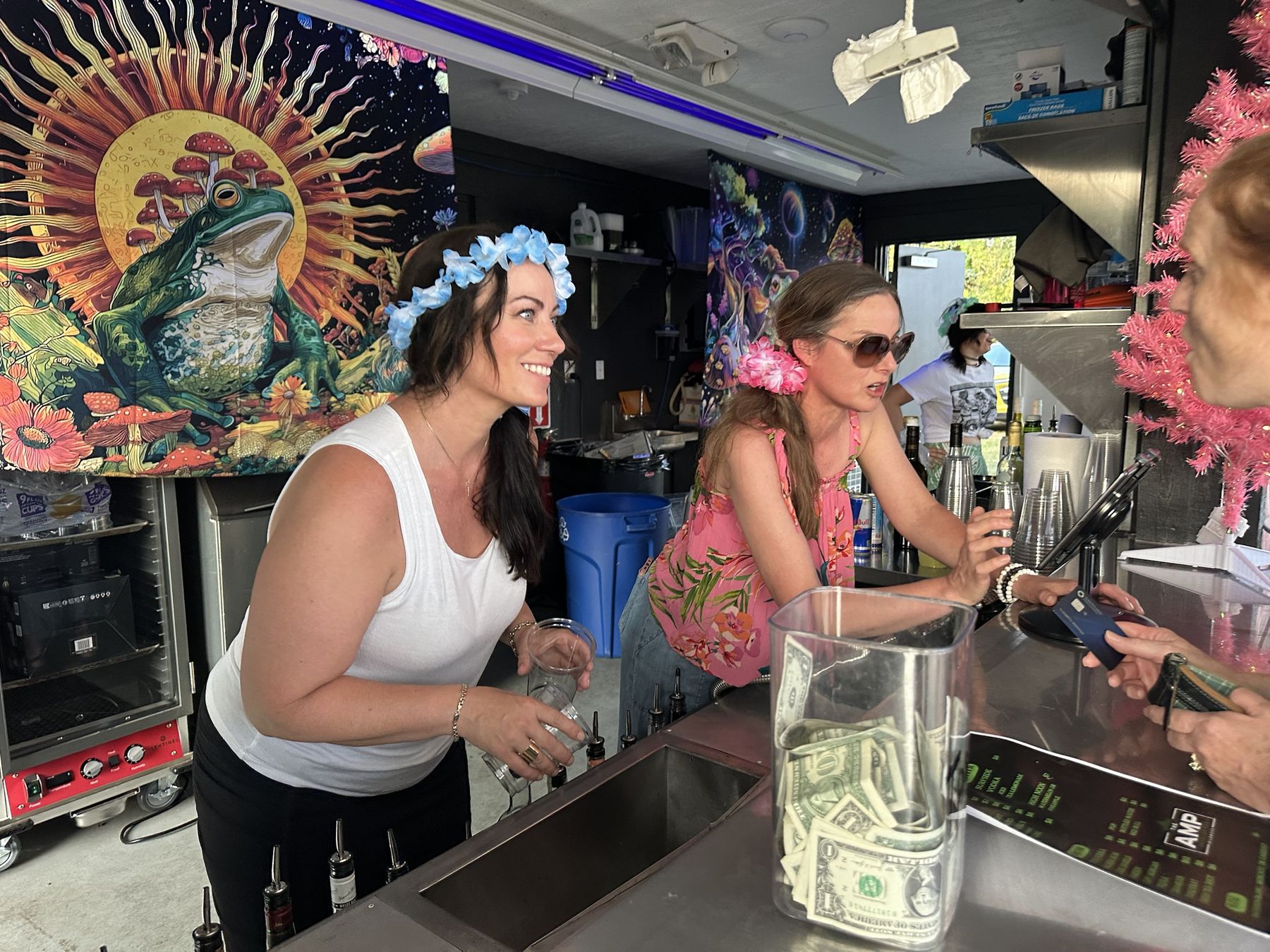 Bartenders in flower crowns serving at the AMP