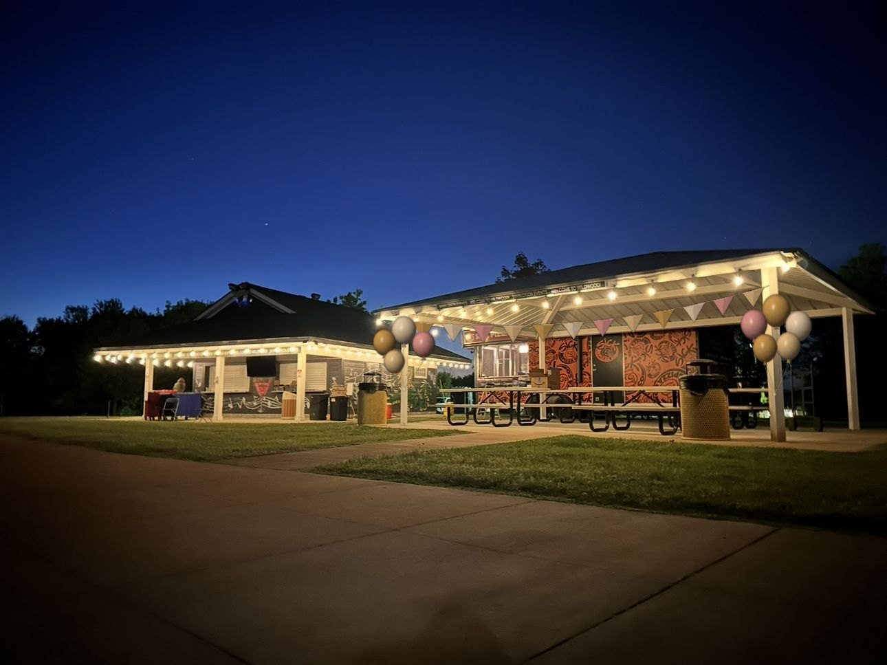 The Wildwood party pavilion lit with string lights and balloons at night